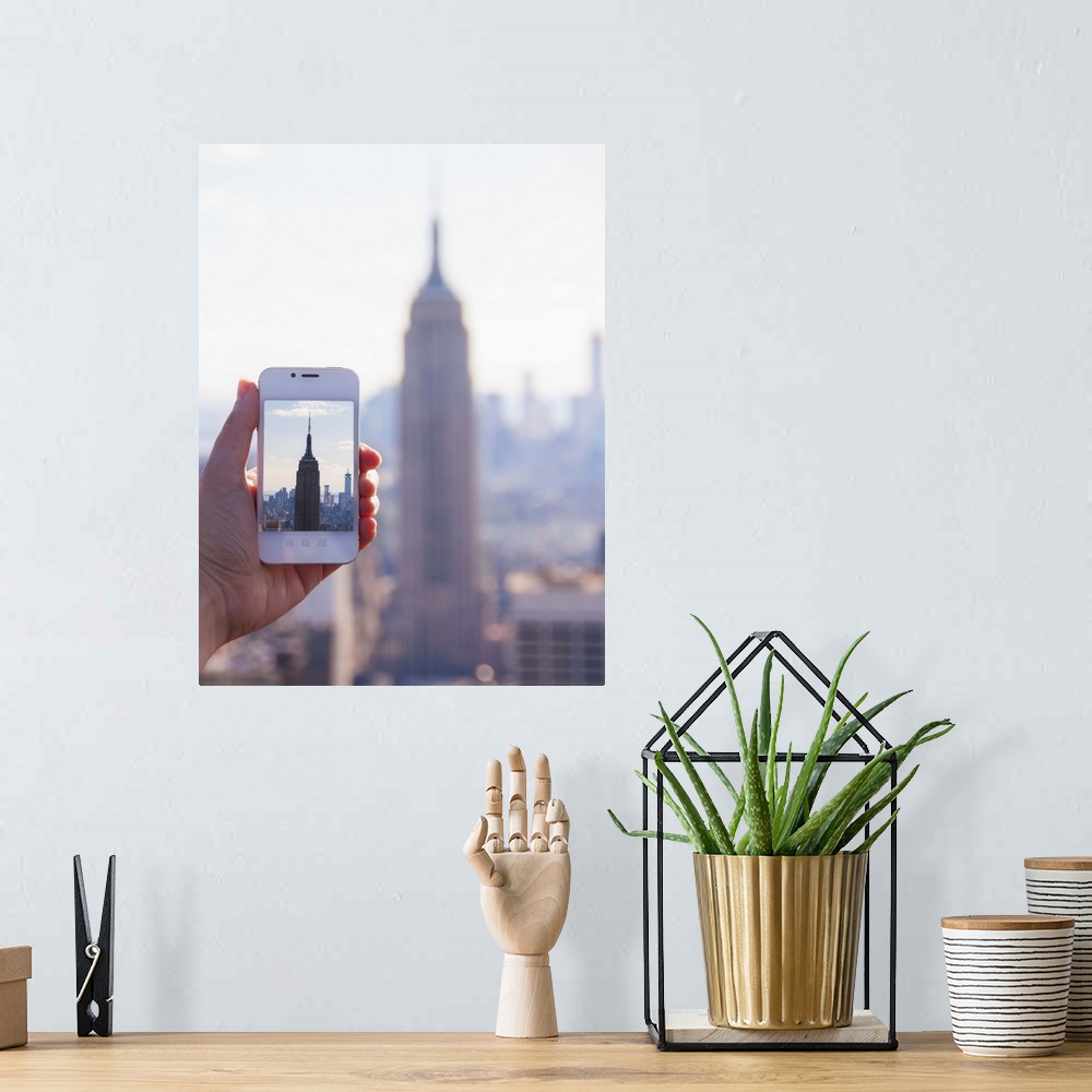 A bohemian room featuring USA, New York State, New York City, Manhattan, Tourist taking photo of Empire State Building