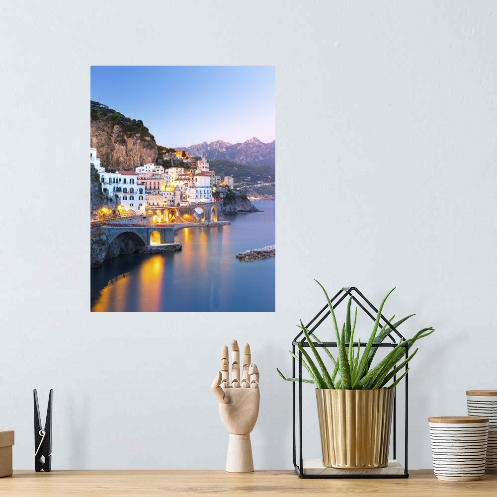 A bohemian room featuring Night view of Amalfi cityscape on coast line of Mediterranean sea, Italy.