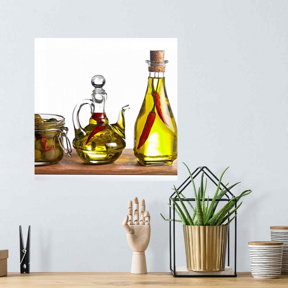 A bohemian room featuring Oil with chillies and olive against white background, close-up
