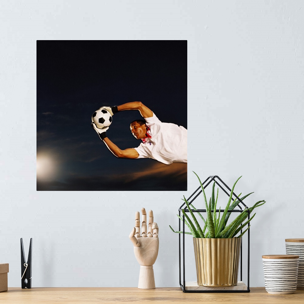 A bohemian room featuring shot of a soccer goalkeeper making a save