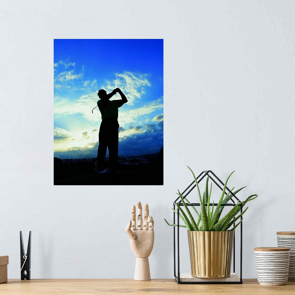 A bohemian room featuring silhouette of a golfer after a swing