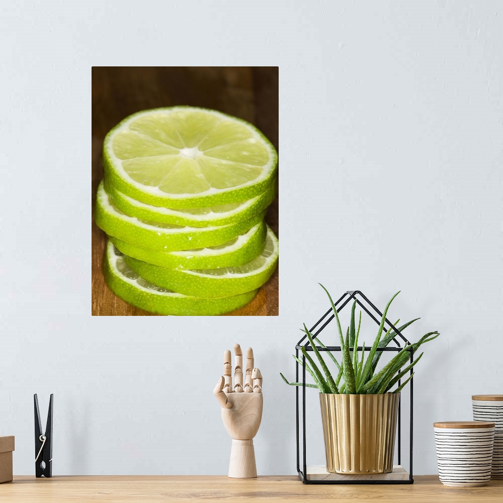 A bohemian room featuring stacked sliced limes on wood cutting-board