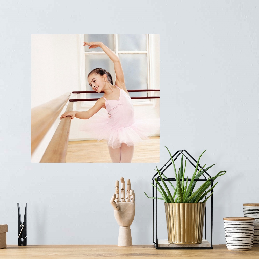 A bohemian room featuring Young Girl in a Tutu Practises Ballet in a Studio