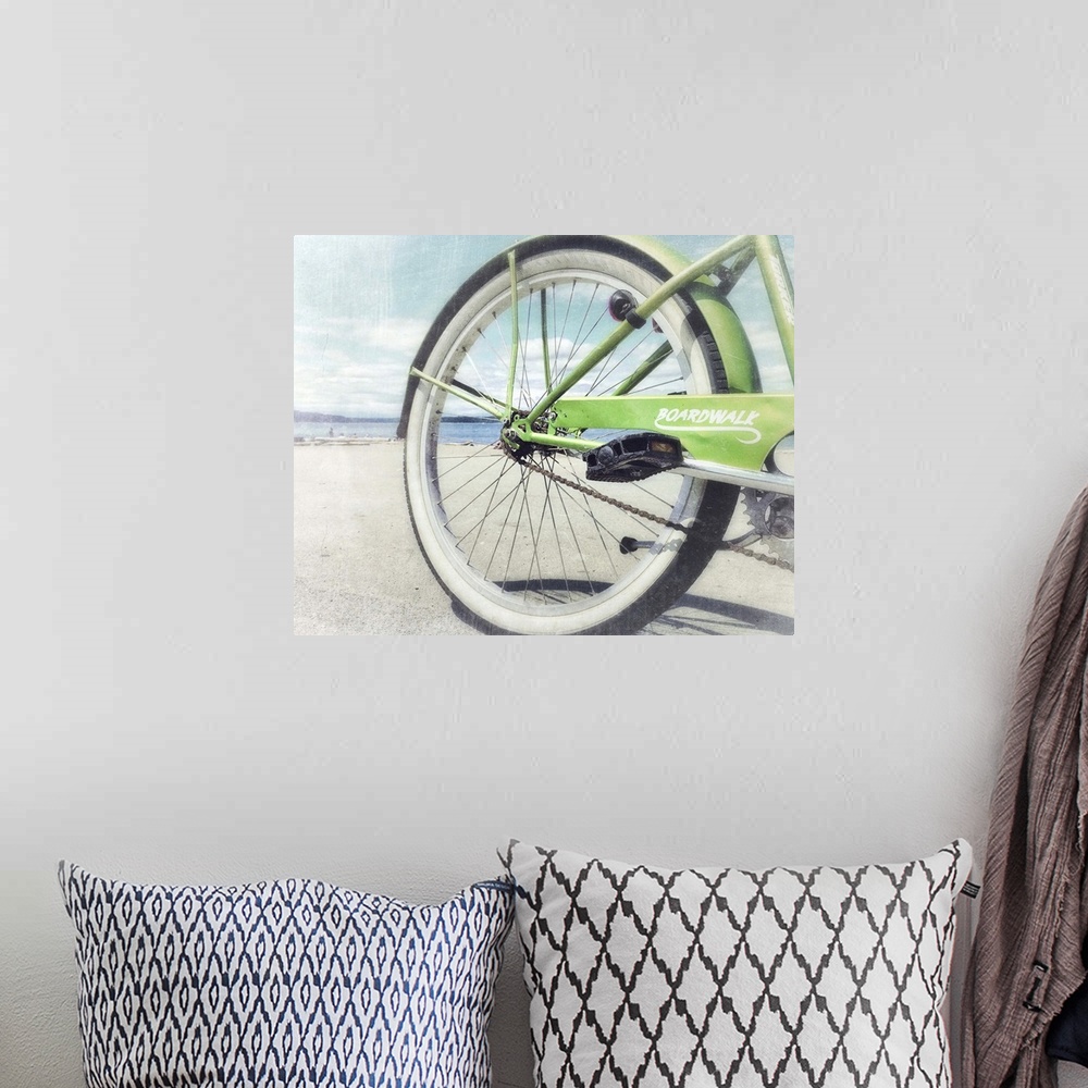 A bohemian room featuring Aged photograph of the rear of a green bicycle with a slightly blown out beach scene in the backg...