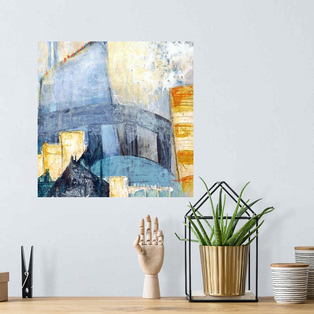 A bohemian room featuring Square abstract painting of a cityscape using shades of blue, yellow, orange, and grey.