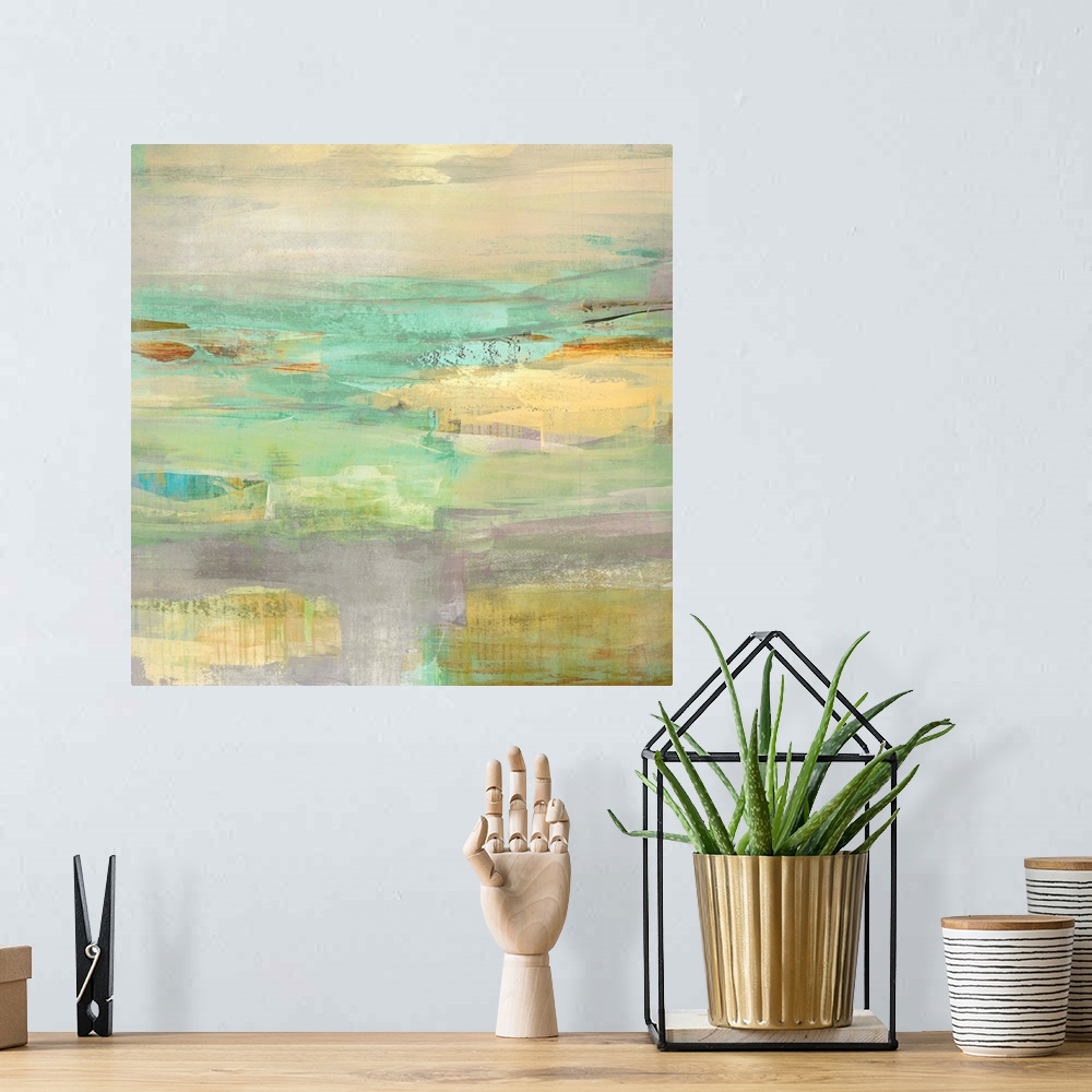 A bohemian room featuring Square abstract painting layered with green, blue, purple, yellow, and orange hues.