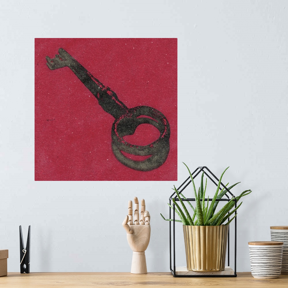 A bohemian room featuring Square art of an antique key on a red background.