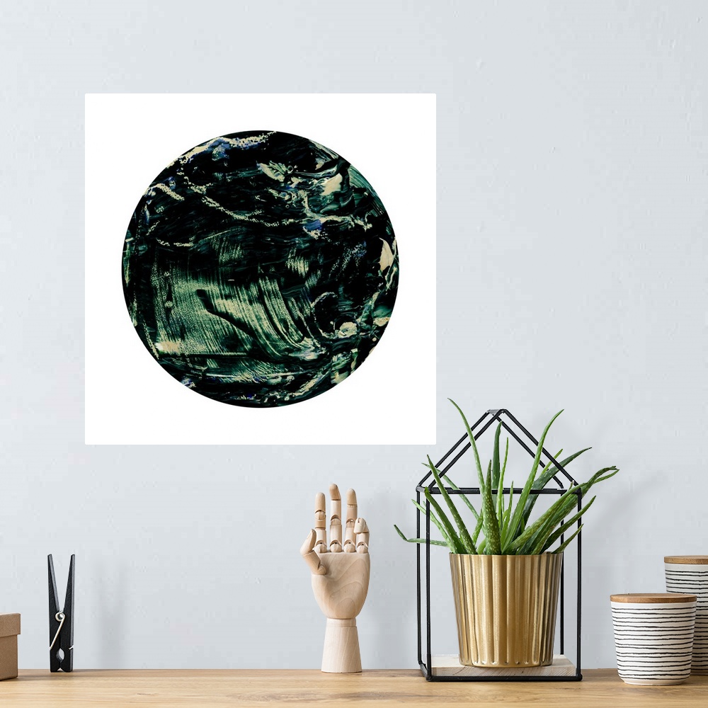 A bohemian room featuring A contemporary abstract painting using dark green in a circle against a white background.