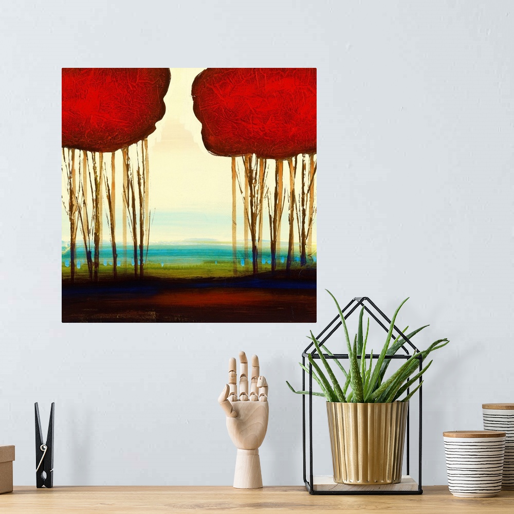 A bohemian room featuring A piece of contemporary artwork that shows two groupings of trees that have red tops. The bottom ...