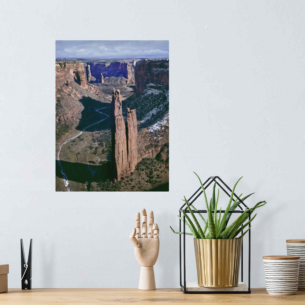 A bohemian room featuring A photograph of a towering rock formation in a desert canyon.