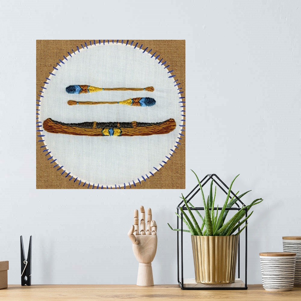 A bohemian room featuring Contemporary embroidered artwork of a canoe sewn onto a white circle against a brown background.