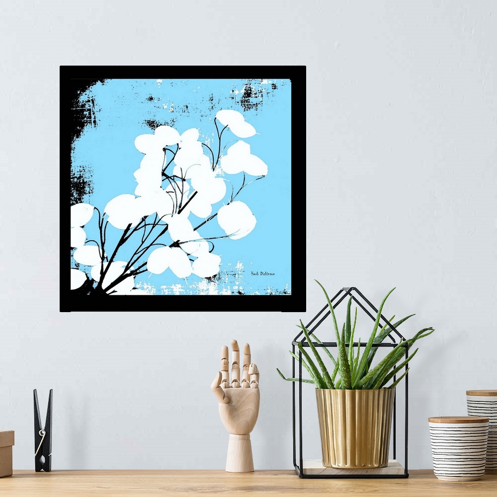 A bohemian room featuring Square silhouetted painting of a money plant in black, white, and light blue.