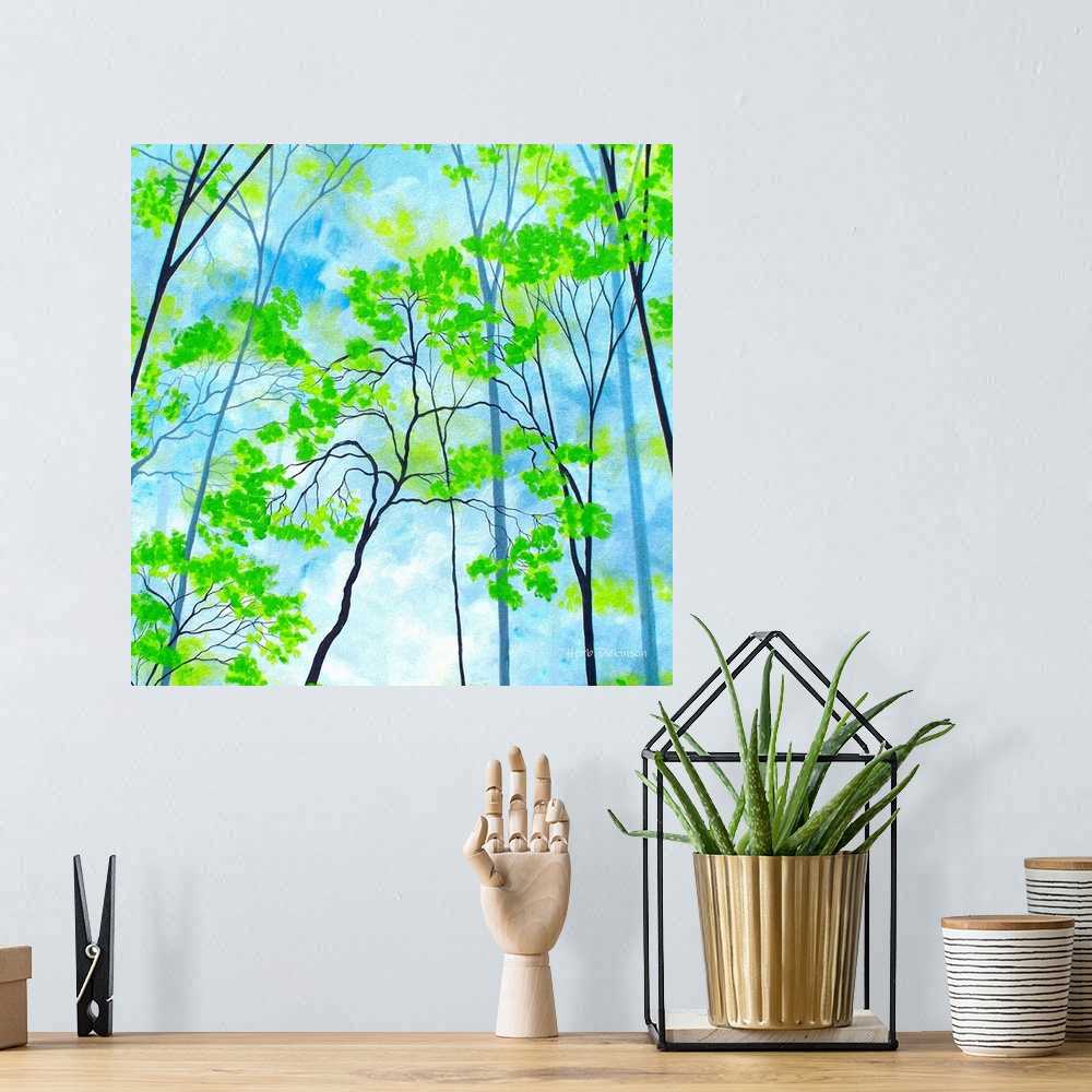 A bohemian room featuring Square painting with bright green tree tops on a cloudy blue background.
