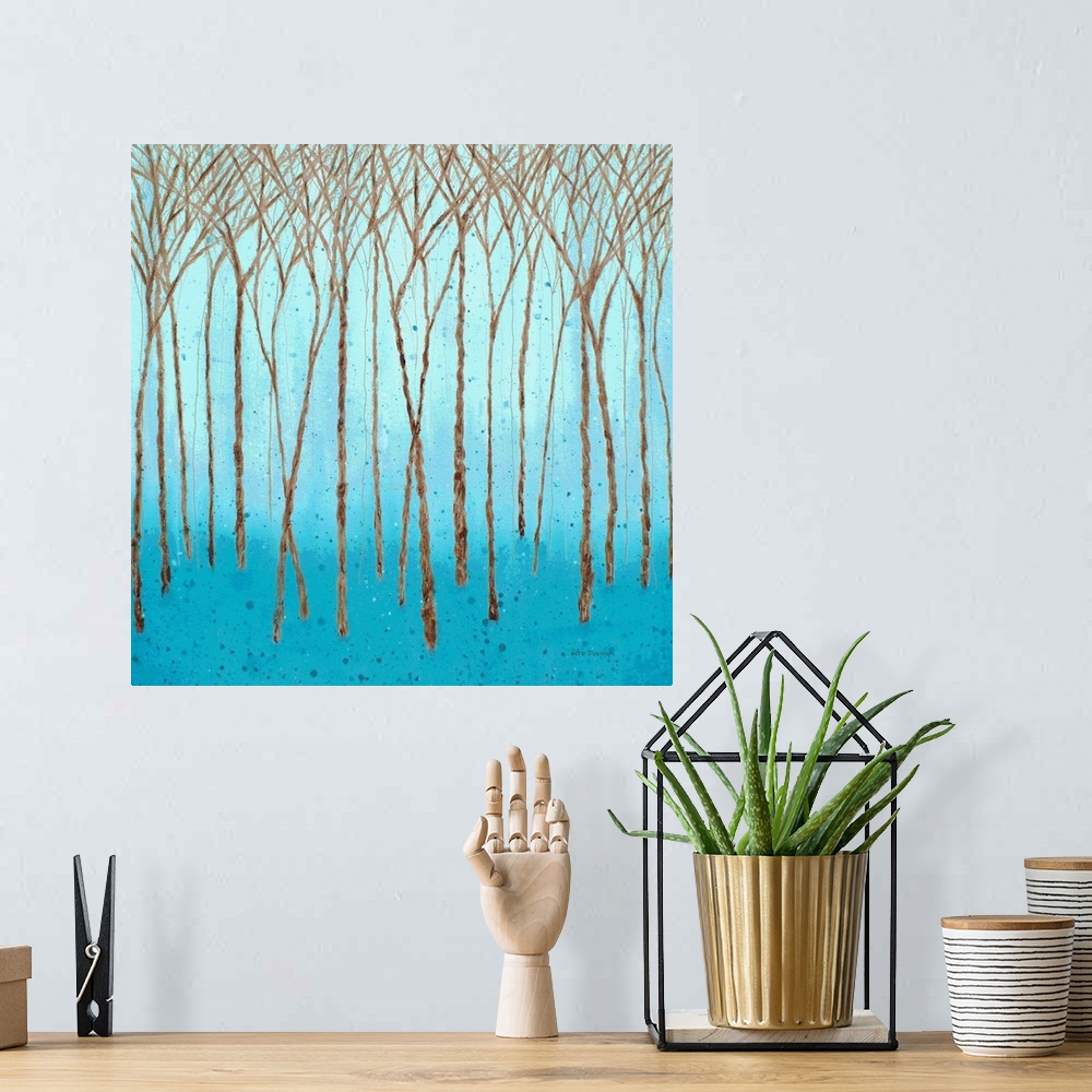 A bohemian room featuring Brown Winter trees on a square background made with shades of blue and paint splatter.
