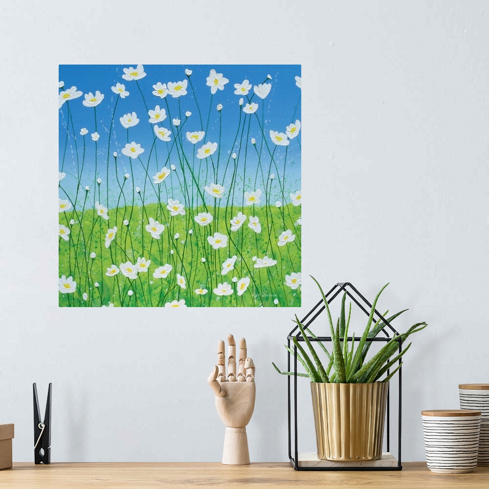 A bohemian room featuring Square painting of white daisies with long, thin stems in a field with a blue sky in the background.