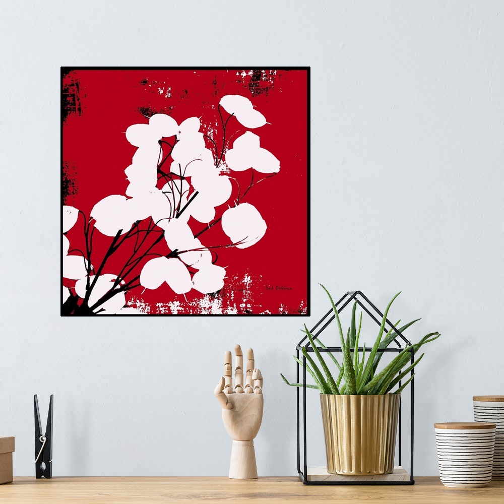 A bohemian room featuring Square silhouetted painting of a money plant in red, black, and white with a black boarder.