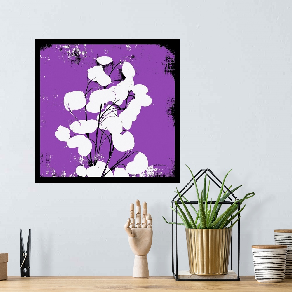 A bohemian room featuring Square silhouetted painting of a money plant in bright purple, black and white with a black boarder.
