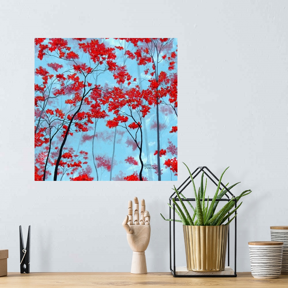 A bohemian room featuring Square painting of tree tops with red leaves on a light blue background.