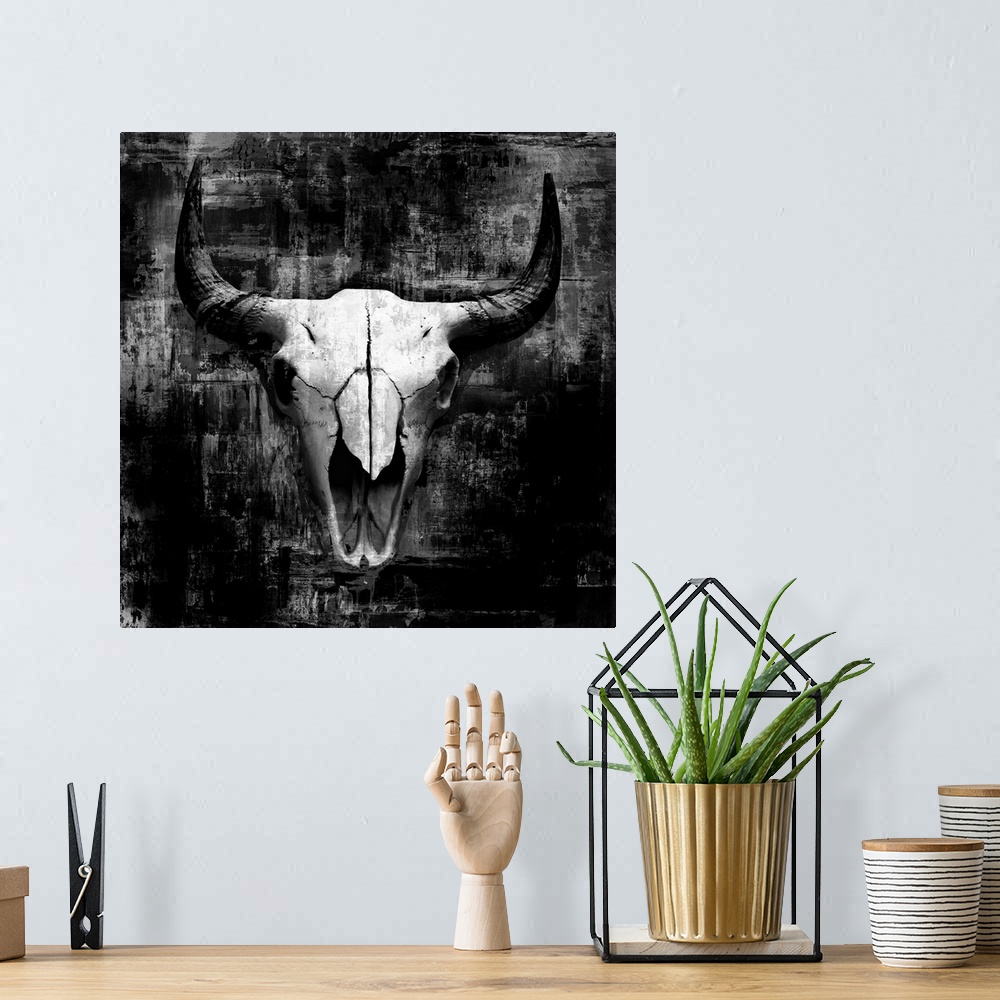A bohemian room featuring A digital illustration of a cow skull in black and white with a rustic textured effect.