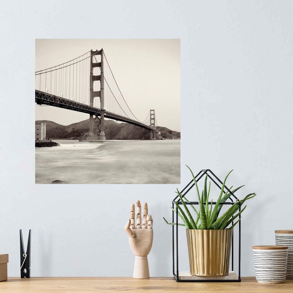 A bohemian room featuring A black and white photograph of the Golden Gate Bridge in San Francisco.