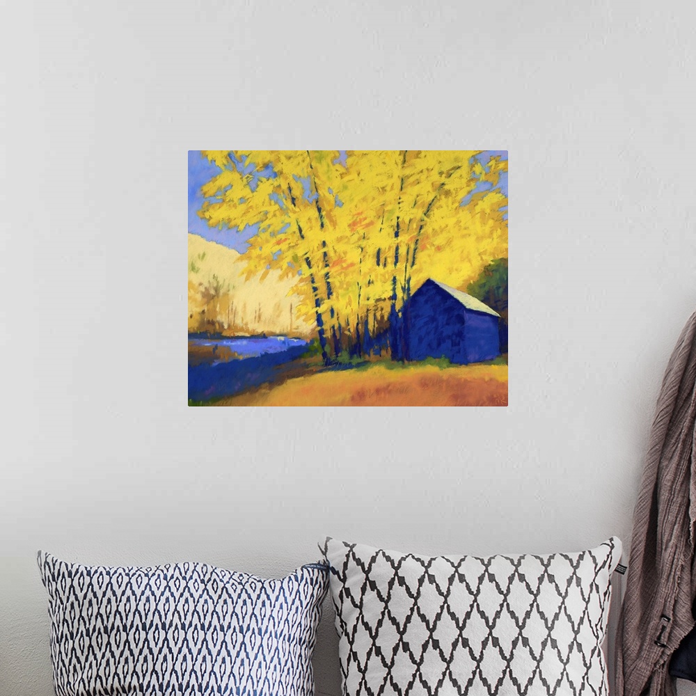 A bohemian room featuring A contemporary painting of a building and trees with yellow leaves.