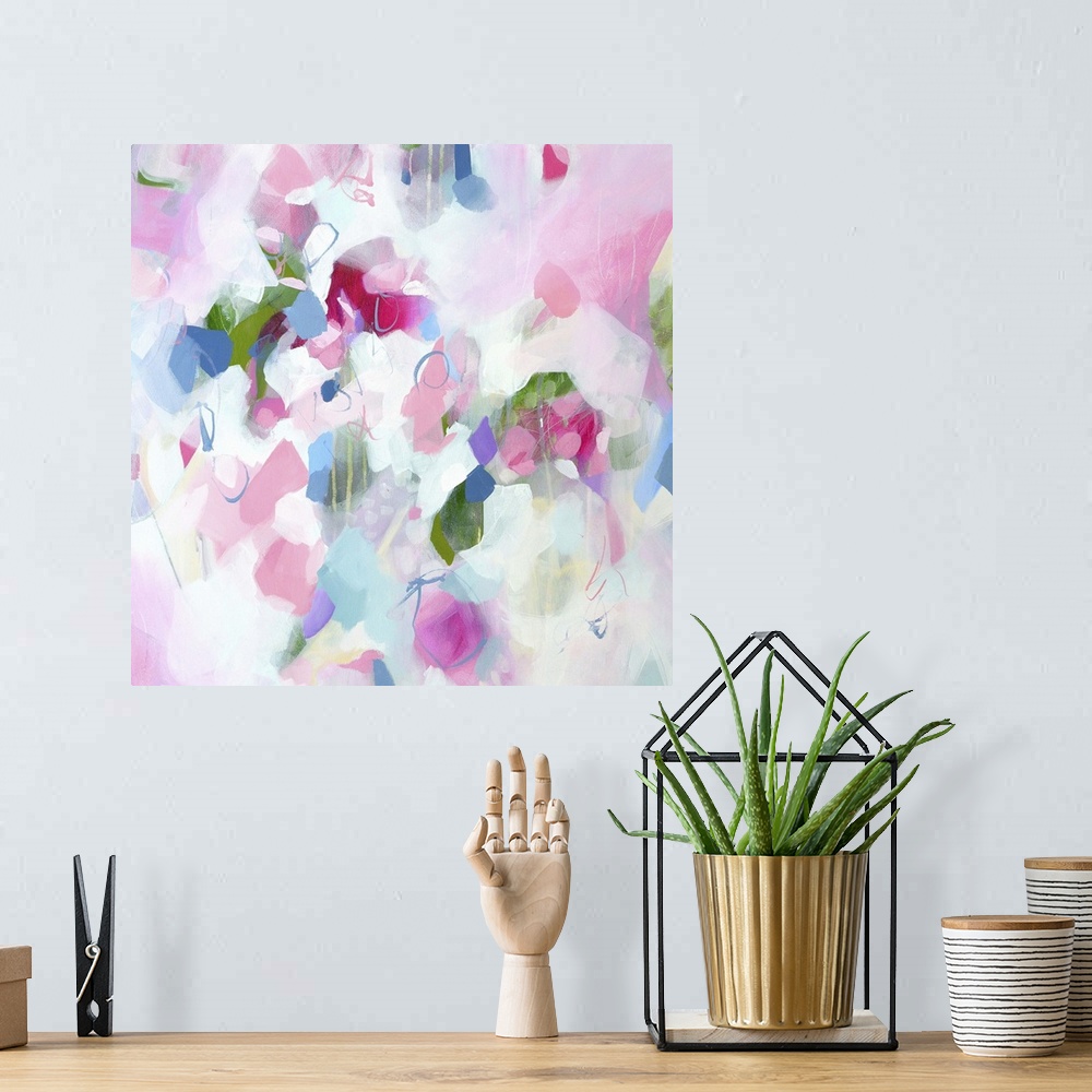 A bohemian room featuring Abstract artwork in cheerful shades of pink, white, and blue.