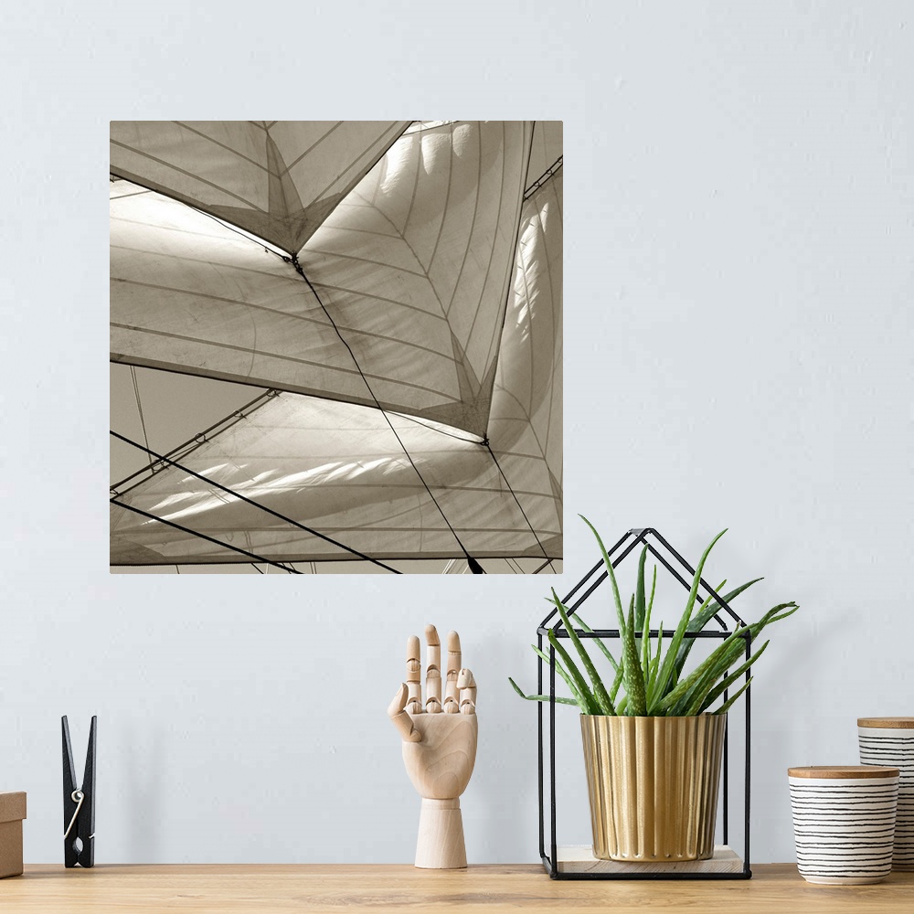 A bohemian room featuring Monochromatic image of multiple sails on a sailboat.