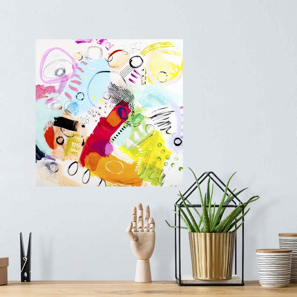 A bohemian room featuring A colorful contemporary abstract piece of art using wild colors and shapes.