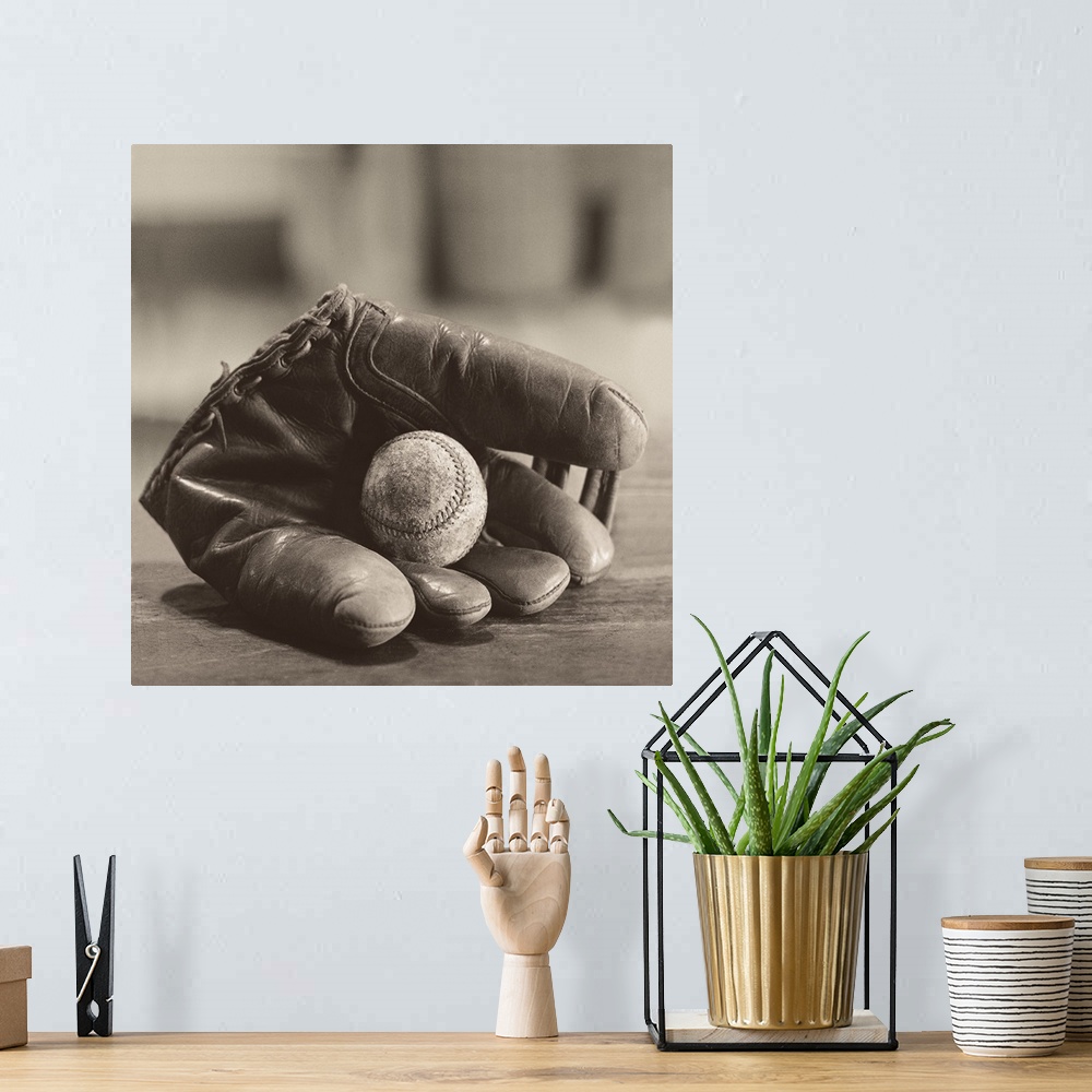 A bohemian room featuring Photograph in sepia tones of a baseball mitt with a baseball by Judy B. Messer.