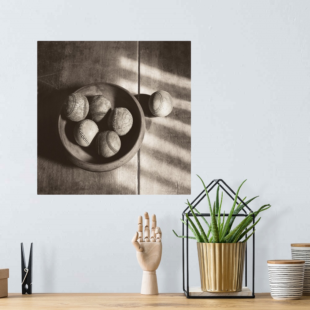 A bohemian room featuring Photograph in sepia tones of a bowl of baseballs by Judy B. Messer.