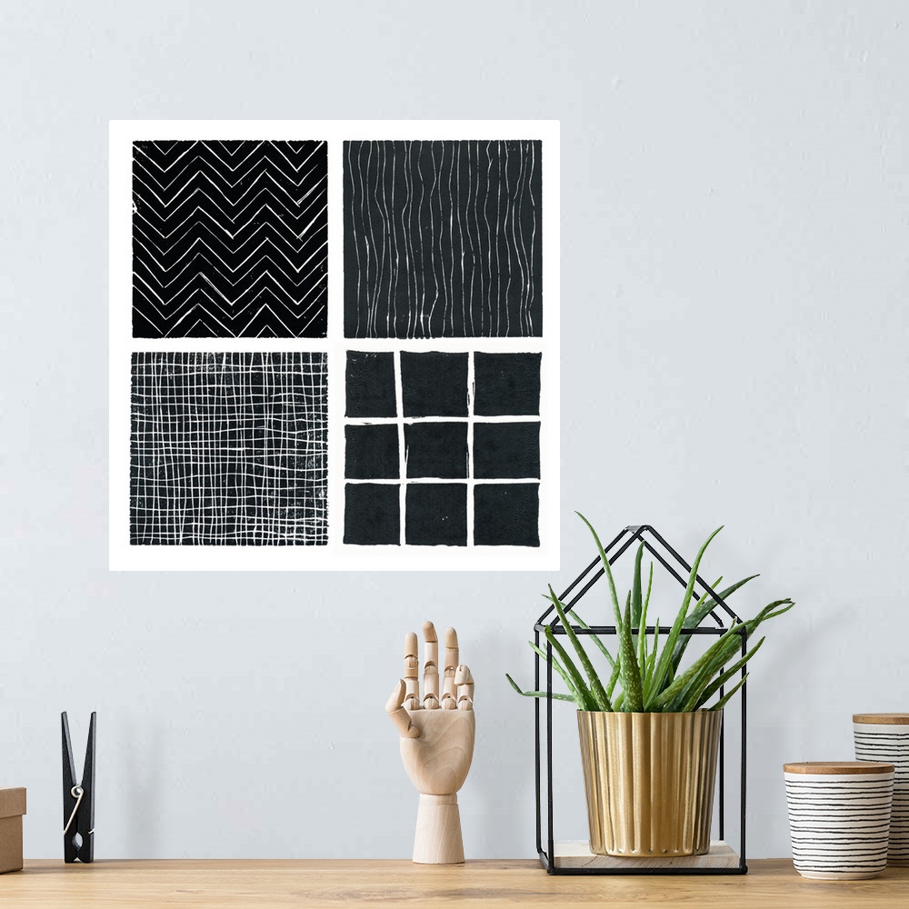 A bohemian room featuring Four b/w prints done with lino blocks and grouped as a single print.