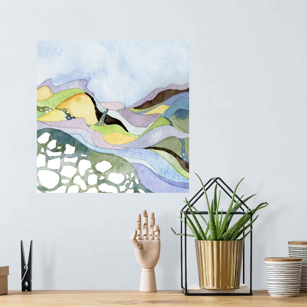 A bohemian room featuring Contemporary watercolor painting of a landscape with a river running through pastel-colored hills.