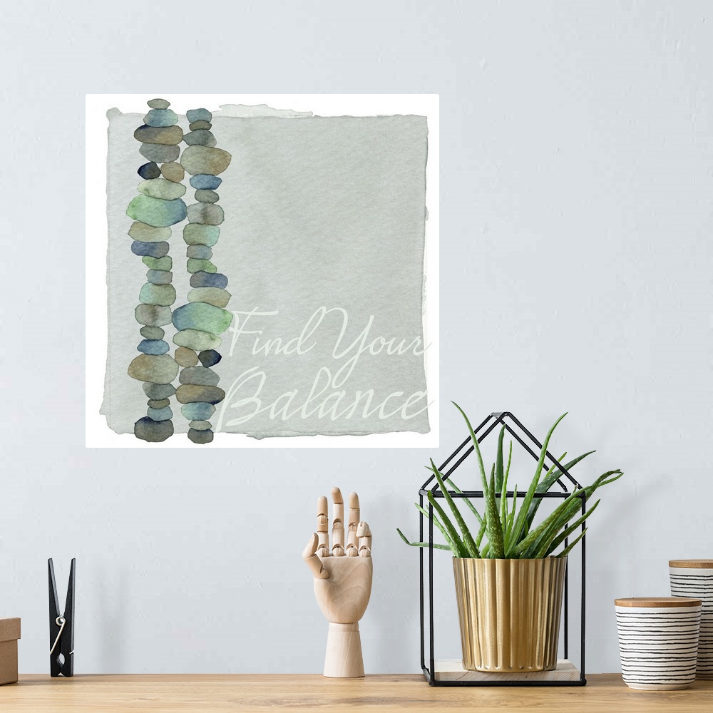 A bohemian room featuring Decorative watercolor painting of two stacks of round stones in blue and green shades with the wo...