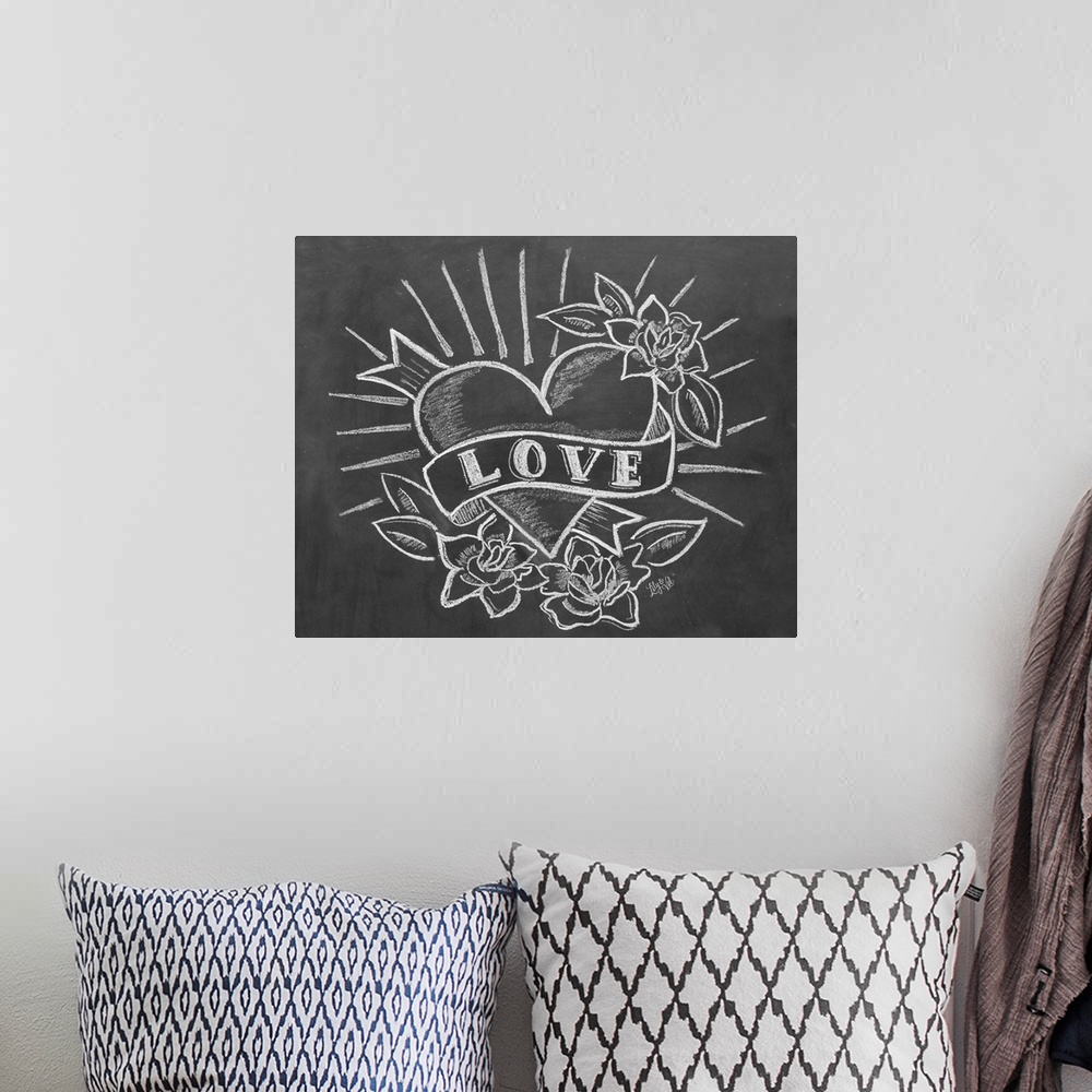 A bohemian room featuring "Love" with a tattoo-style heart drawing in white chalk on a black background.