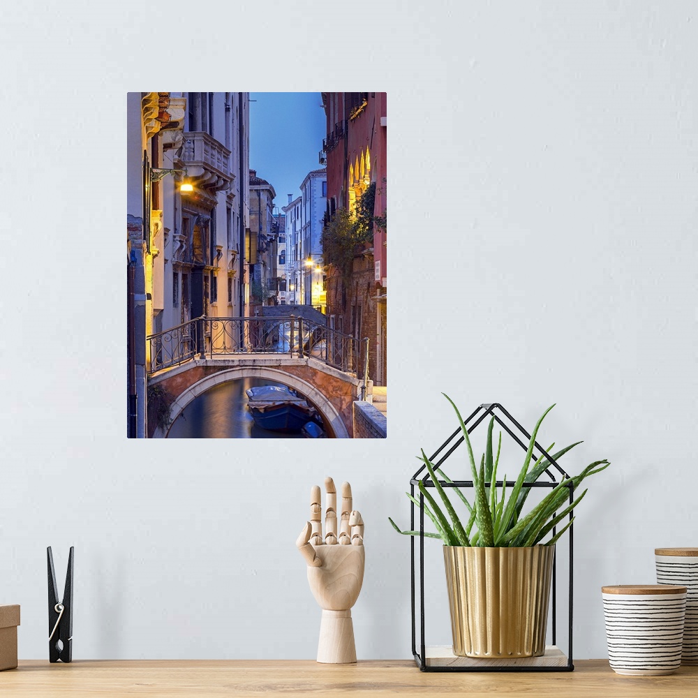 A bohemian room featuring Venice, Veneto, Italy. View over a bridge and a canal at dusk.