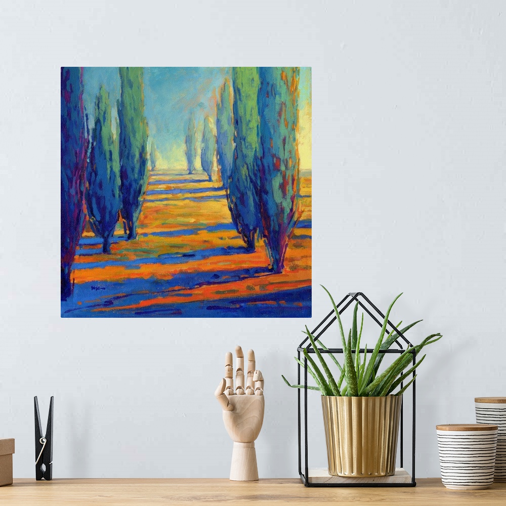 A bohemian room featuring A contemporary painting of a divide between a row of cypress trees.