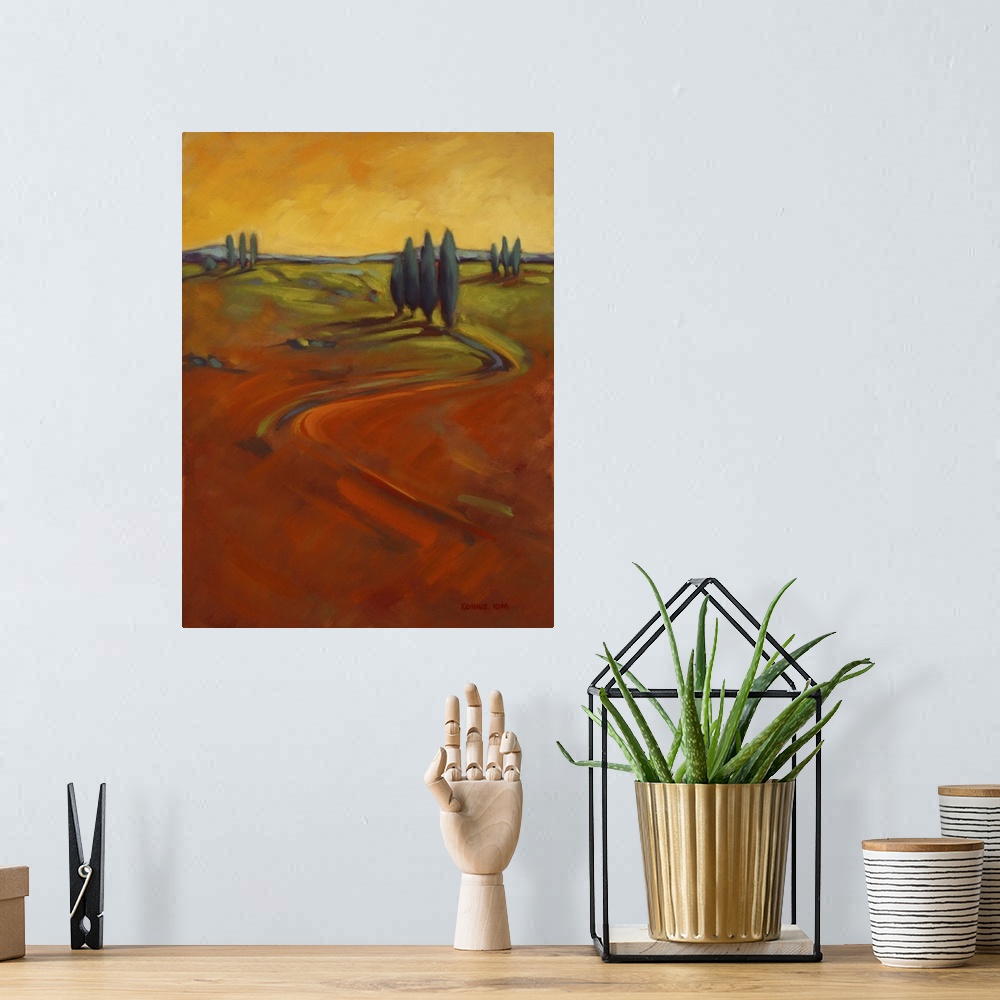 A bohemian room featuring A contemporary painting of cypress trees on a hill in warm colors of orange and yellow.