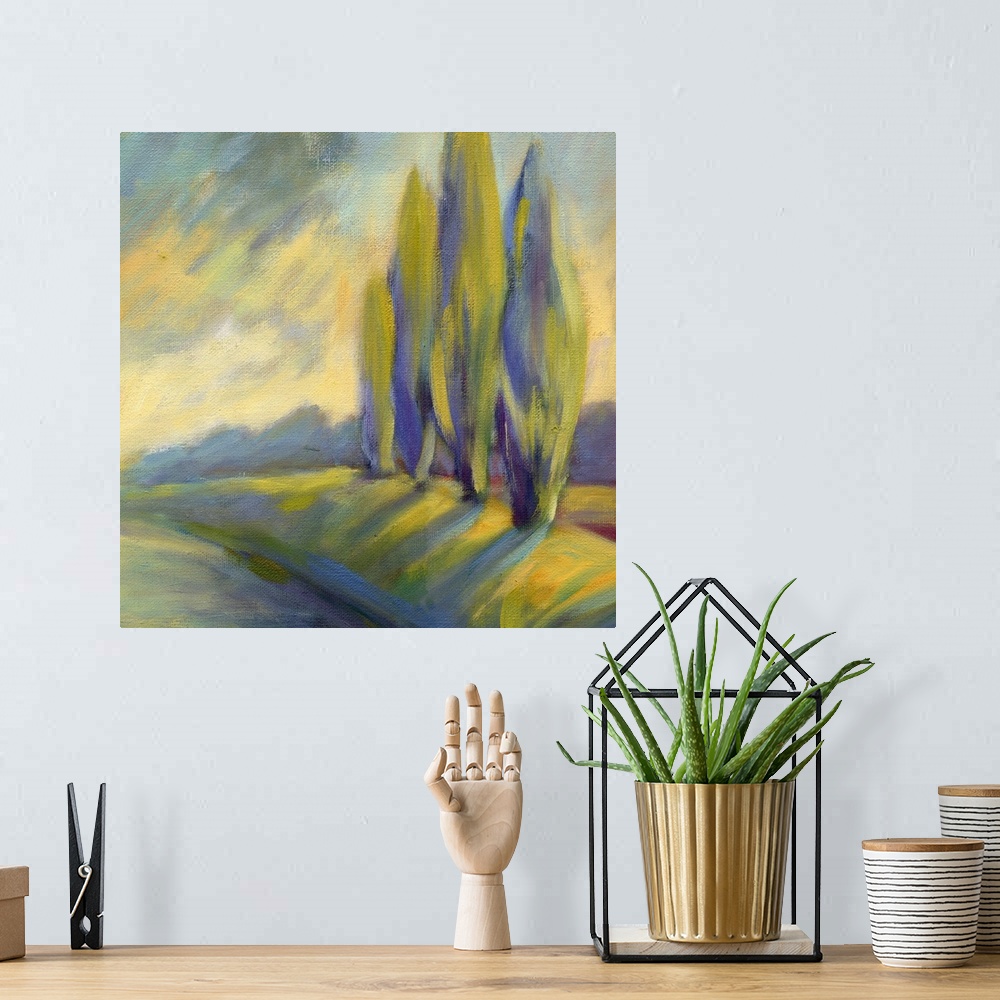 A bohemian room featuring A square painting of a row of cypress tress next to a road.