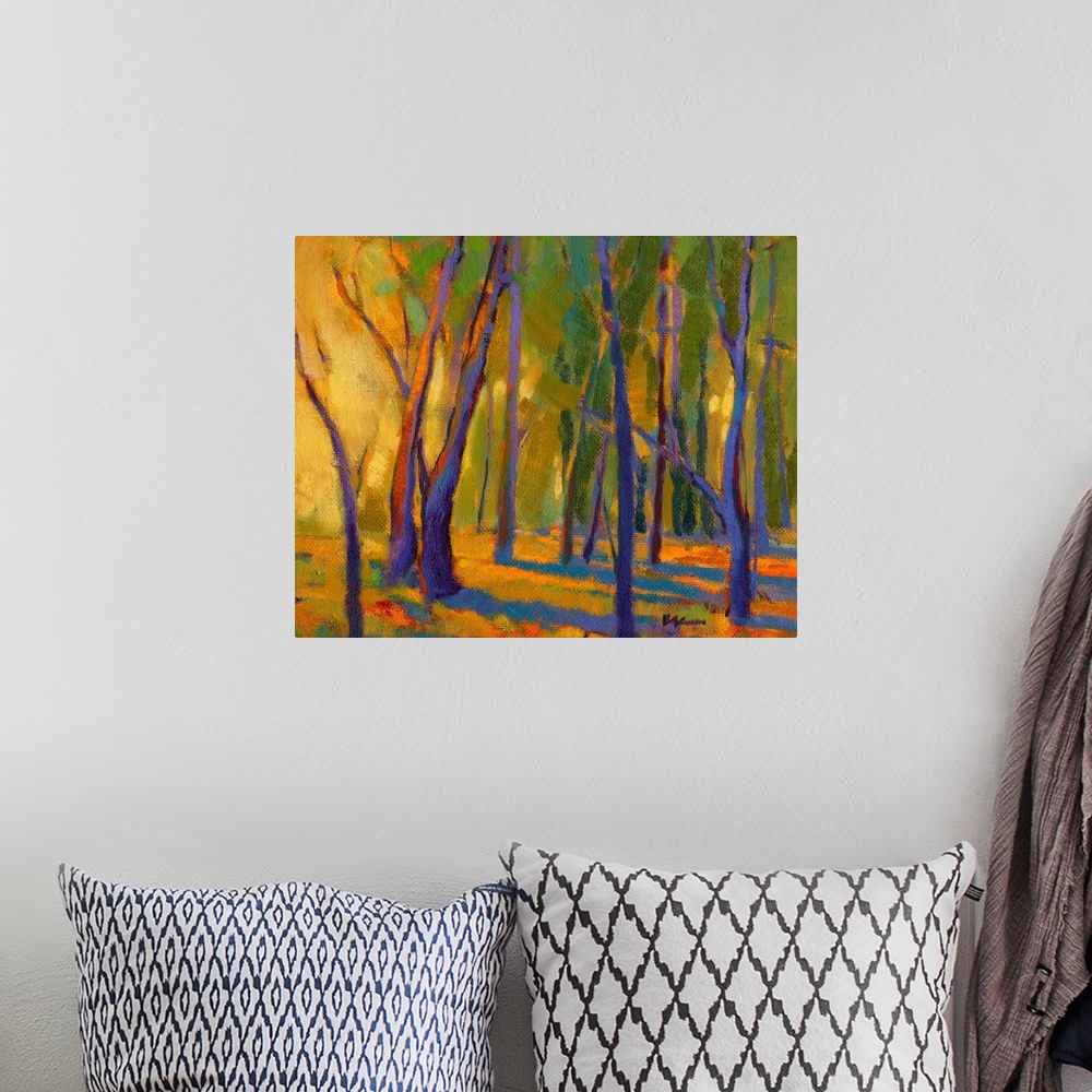 A bohemian room featuring Contemporary painting of trees in a forest with strong golden light shining through at golden hour.