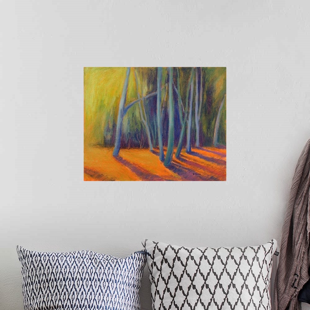 A bohemian room featuring A multicolored painting of a forest of trees.