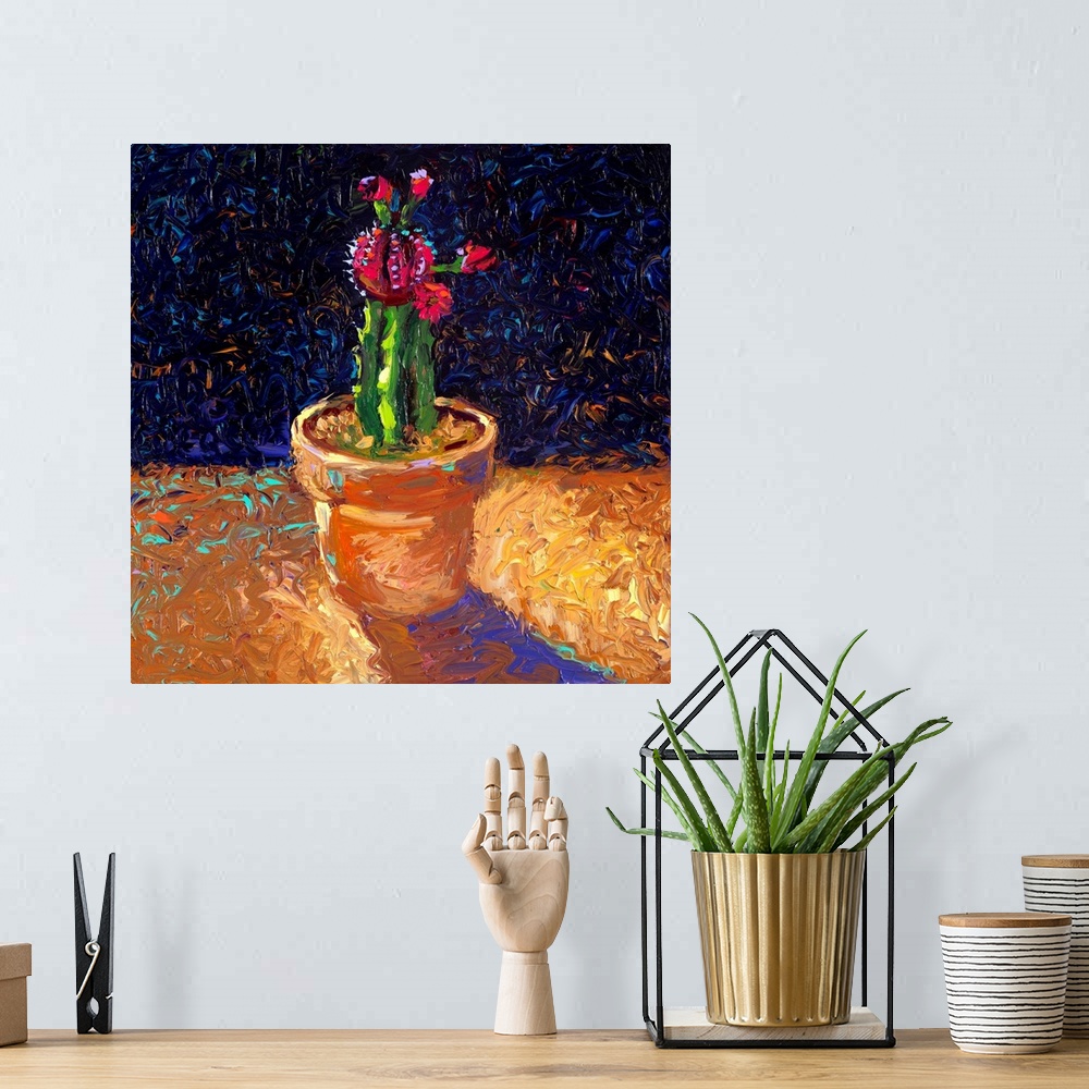 A bohemian room featuring Brightly colored contemporary artwork of a cactus in a pot.