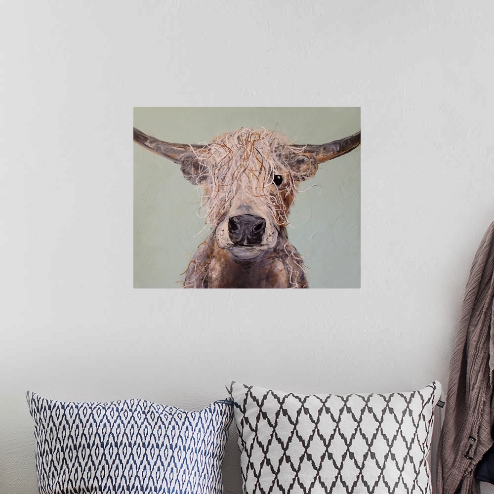 A bohemian room featuring Portrait of a cow with shaggy hair and long horns.