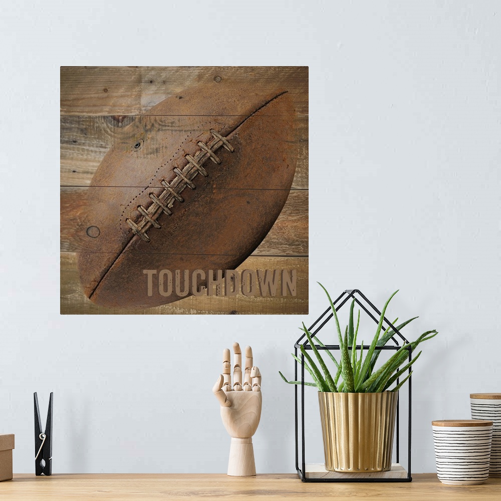 A bohemian room featuring Image of a football with the word "Touchdown" on a wooden background.