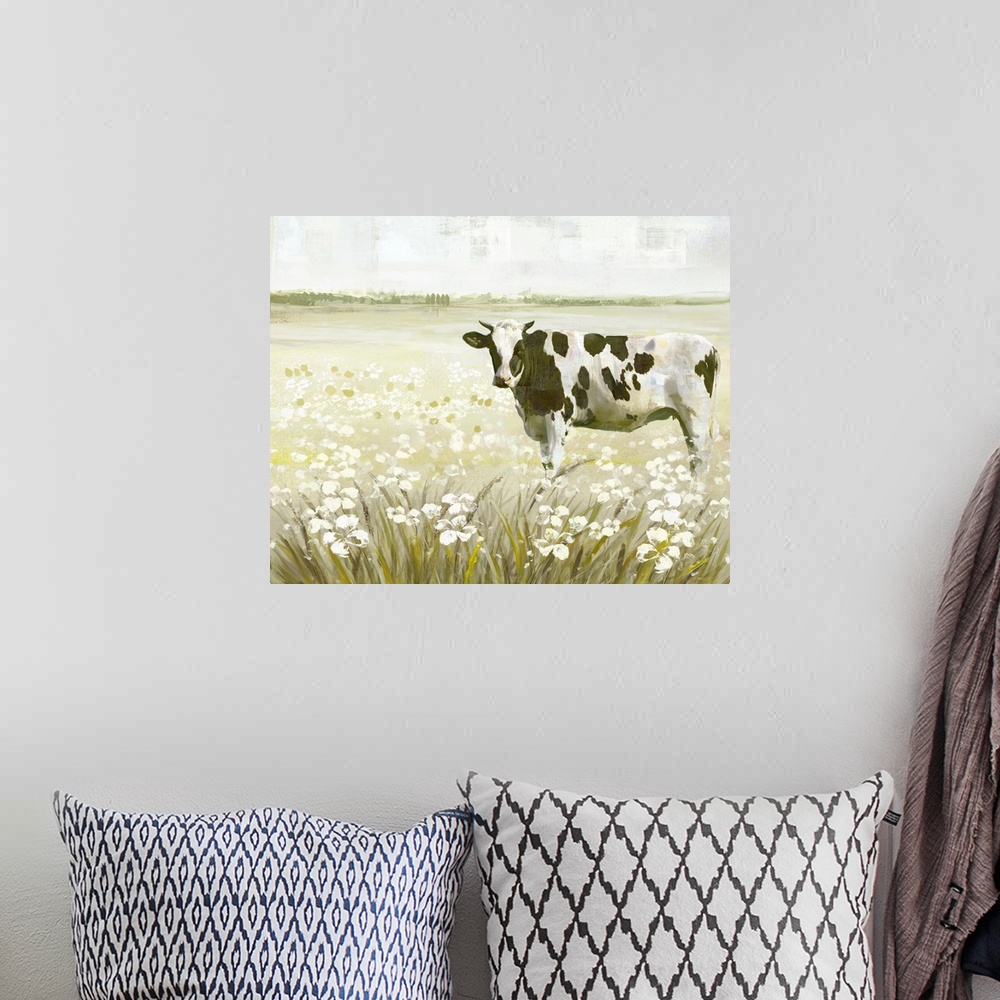 A bohemian room featuring Decorative artwork of a black and white cow in a field full of flowers.