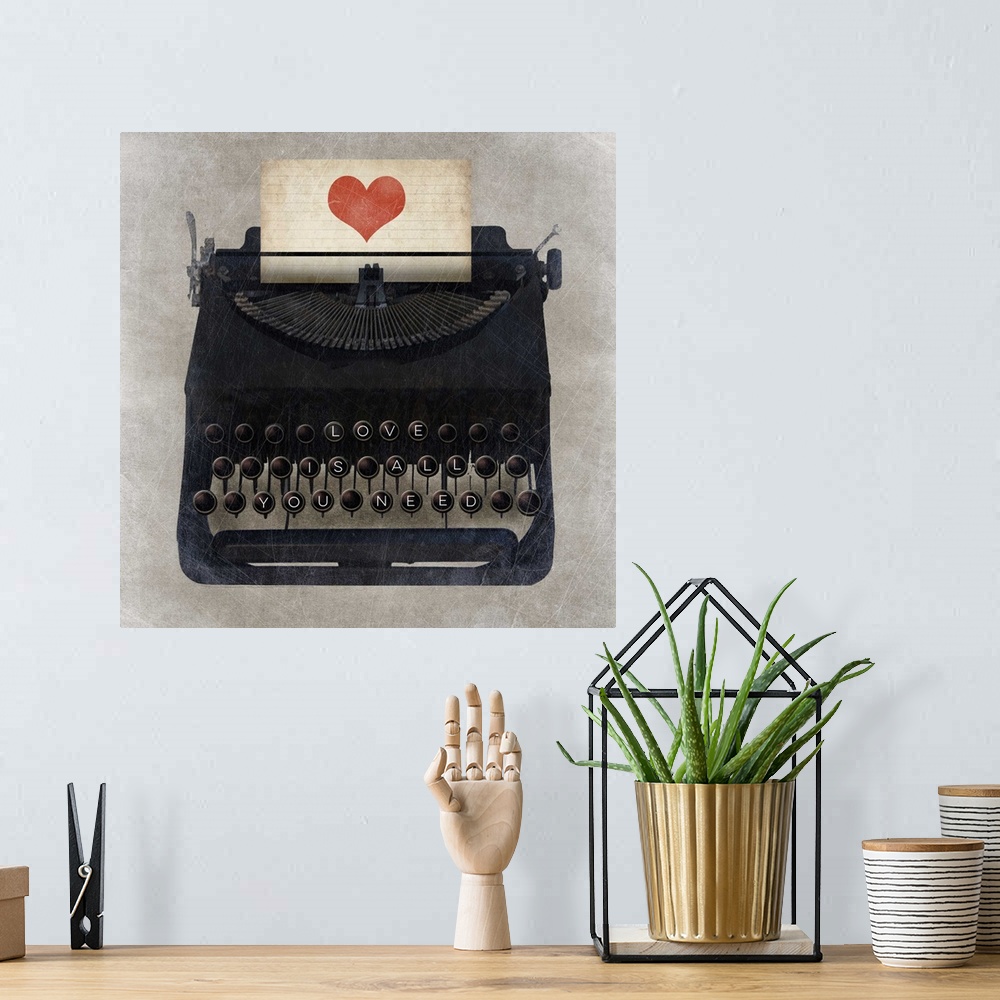 A bohemian room featuring A vintage typewriter with "Love is all you need" on the keys and a heart on the paper.