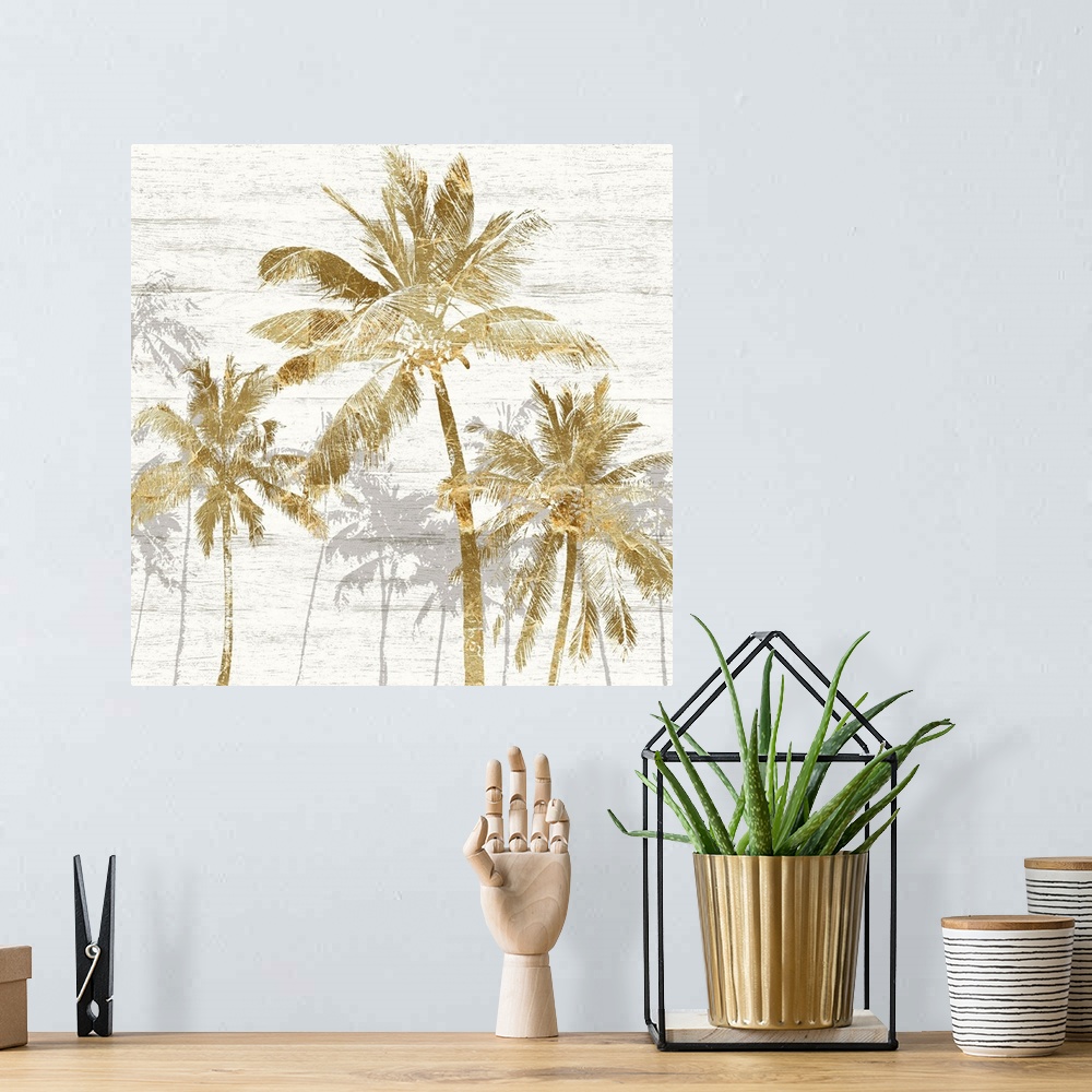 A bohemian room featuring Square artwork of a group of gold palm trees with gray trees behind, on a white wood backdrop.