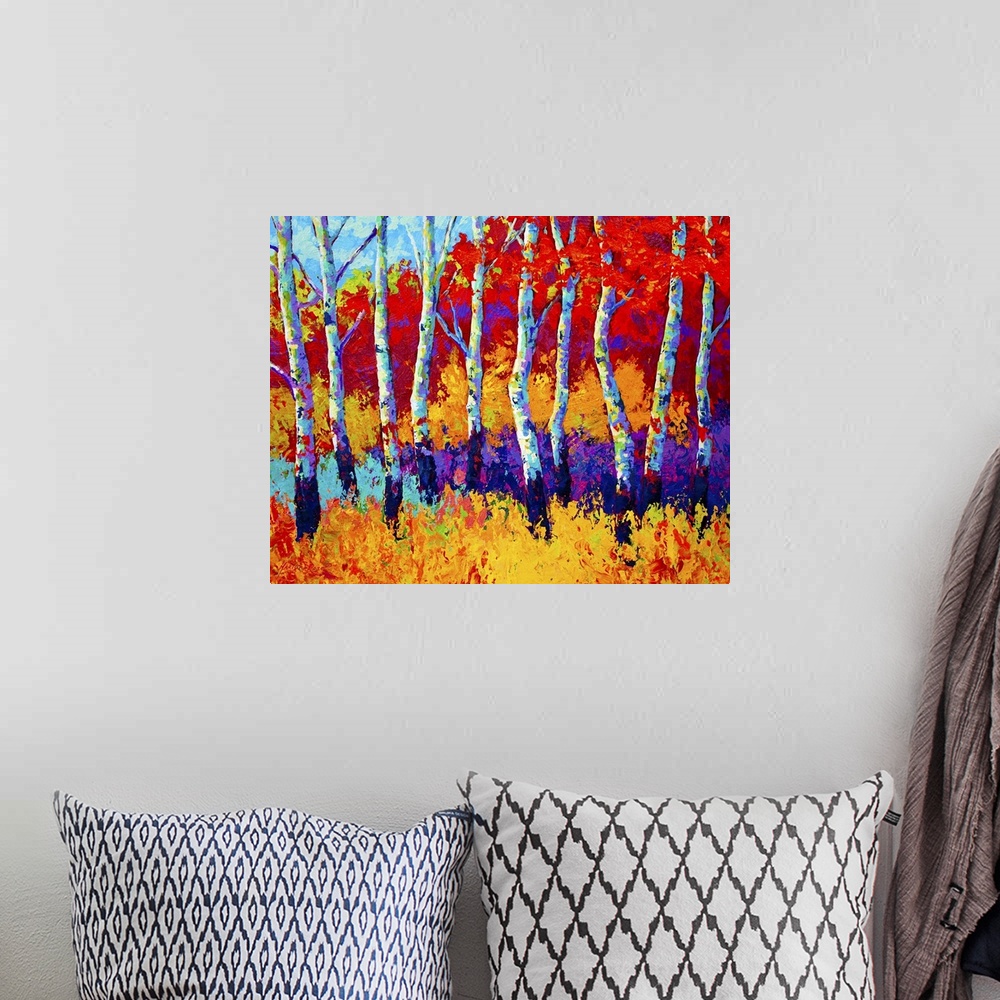 A bohemian room featuring Large abstractly painted canvas print of a line of trees with fall foliage in the background.