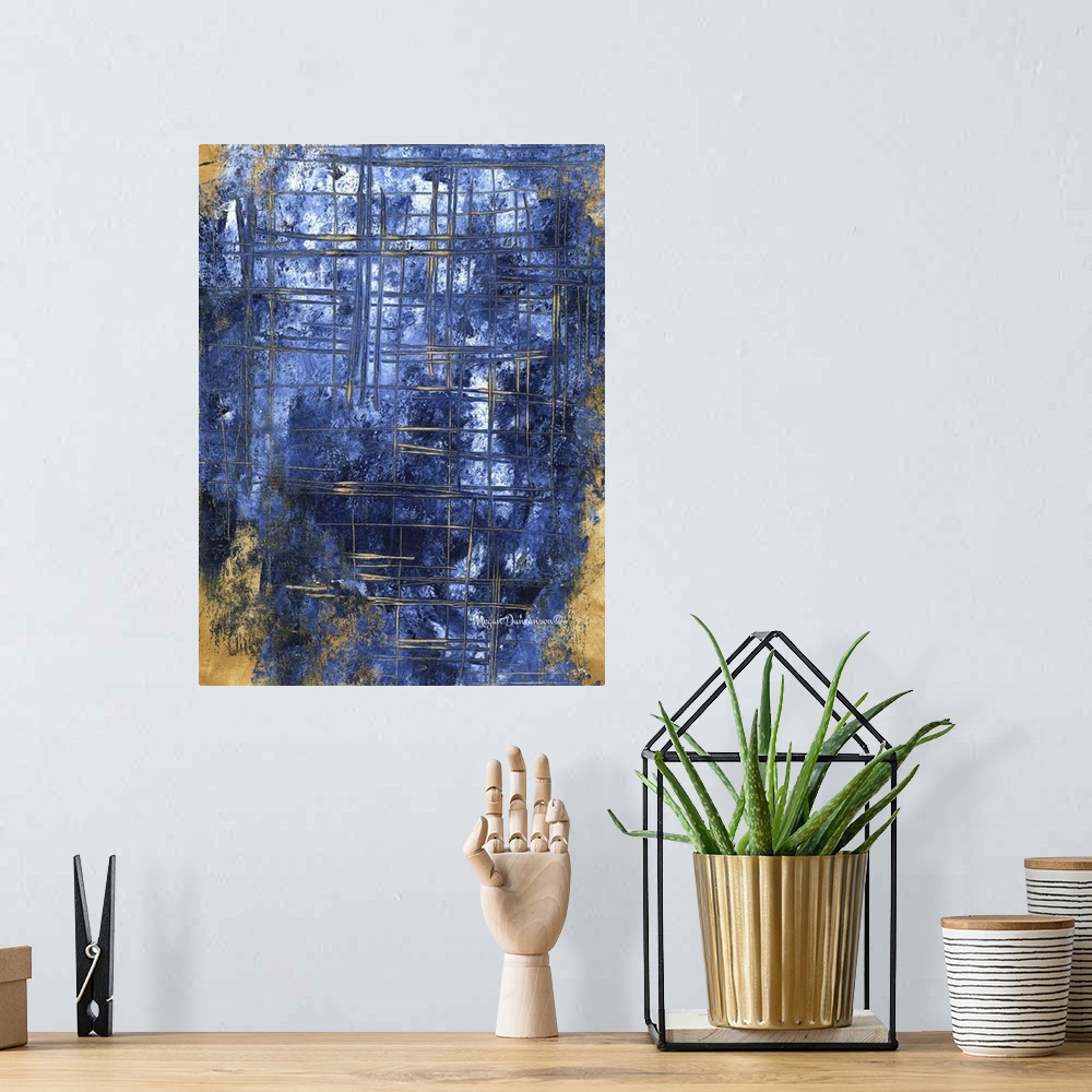A bohemian room featuring A contemporary abstract painting that has a gold background and different shades of dark blue on ...