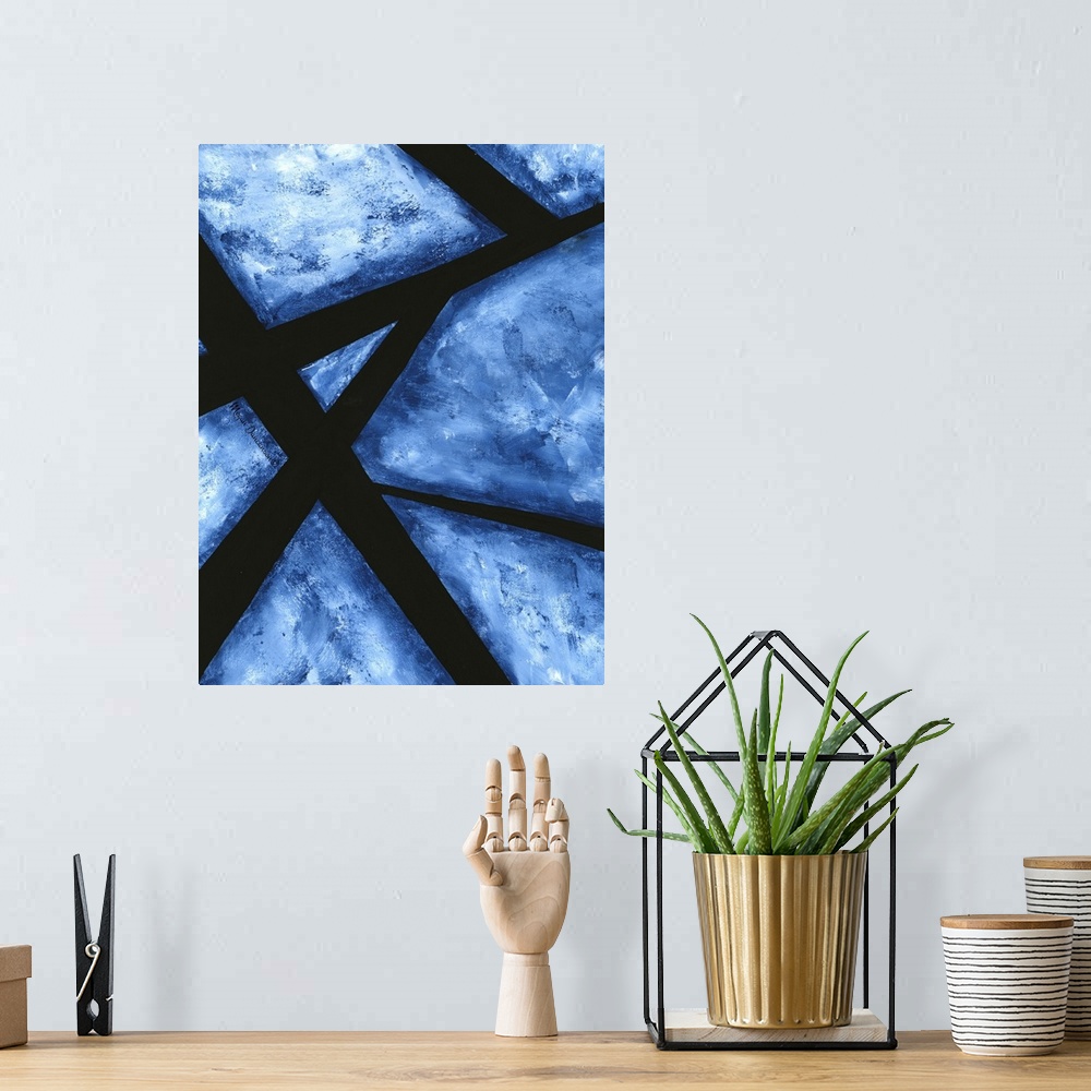 A bohemian room featuring A contemporary abstract painting that has minimal white background covered with dark blue hues an...