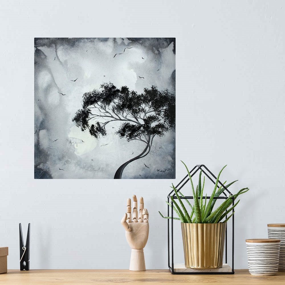 A bohemian room featuring Painting of a lone bending tree on a menacing grey background with small birds flying around the ...
